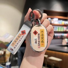 A hand holds a stylish key cover with chinese characters and lucky symbols, designed for electric scooter keys like universe ...