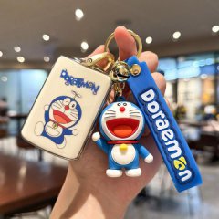 A hand holds a volvo xc60 key cover featuring a doraemon design, paired with a matching doraemon keychain and strap, showcasi...