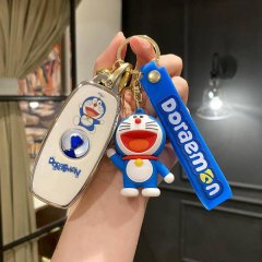 A hand holds a denza d9 car key cover featuring a cute doraemon design, complete with a blue doraemon figure and a doraemon s...