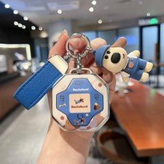 A hand holds a jetour traveler car key cover featuring a dachshund design with a blue and white color scheme, accompanied by ...