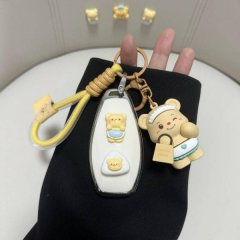 A hand holds a hongqi hs5 car key cover featuring a white full-shell design with cute bear decals and a matching keychain, pe...