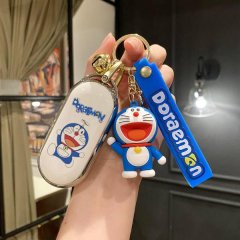 Hand holding a doraemon-themed car key cover and accessories, featuring a full-body design for aito m7 models, with a playful...