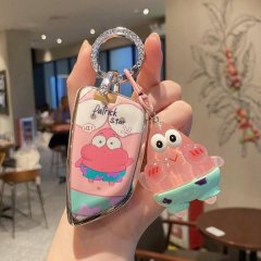 A hand holds a stylish car key cover featuring patrick star from spongebob, paired with a matching translucent charm, designe...