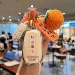 A hand holds a stylish toyota camry car key cover with a tpu shell case, featuring a peach design and the phrase everything w...