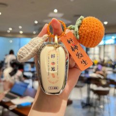 A hand holds a stylish peugeot 4008 car key cover with a good luck charm and orange knitted tag, designed for models like 500...