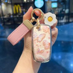 Elegant lincoln corsair key cover featuring a floral design with butterflies, paired with a pink leather strap and gold accen...