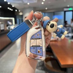 A hand holds a cadillac ct5 key cover featuring an aluminum shell with a playful dog design, complete with a blue strap and m...