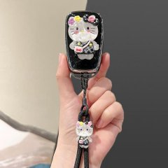 A hand holds a stylish toyota corolla key cover featuring a cute hello kitty design with floral accents and a matching keycha...