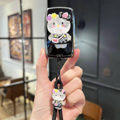 A hand holds a stylish jaguar xel key cover featuring a cute hello kitty design with floral accents and a matching keychain, ...