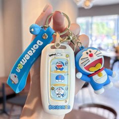 A hand holds a doraemon-themed car key cover for the geely emgrand gs, featuring a cute design with a blue strap and a 3d dor...