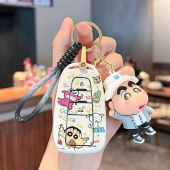 A hand holds a toyota corolla key cover featuring colorful cartoon designs, including a smiling character and playful text, p...