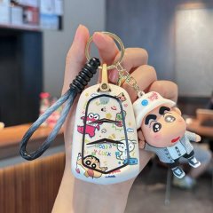 A hand holds a cadillac xt5 key cover featuring a cartoon design with smile and good luck text, paired with a matching keycha...