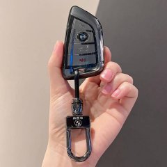 A hand holds a sleek, knife-edge shell case key cover for bmw 3 series, i3, x3, ix3, and x5 models, featuring a polished desi...