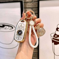 Elegant buick gl8 key cover with gold trim and decorative charms, featuring a sleek design for gl8 landmark/es/lushang models...