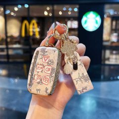 Elegant land rover key cover for range rover evoque sport, featuring a floral design and gold accents, held in hand with a st...