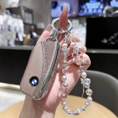Elegant bmw 5 series key cover for 530li and 525i, featuring premium leather with sparkling rhinestones and a beaded keychain...