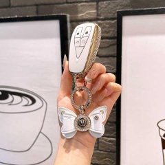 Elegant cs75 plus car key cover with butterfly charm, featuring a sleek white design and gold accents, perfect for changan mo...