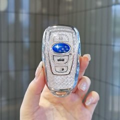 A hand holds a subaru key cover featuring a sparkling tpu design with the iconic subaru logo and functional buttons, perfect ...