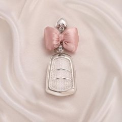Elegant cadillac key cover for xt5, xt4, xts, xt6, ct5, ct4, and srx, featuring a sleek silver design with a pink bow and hea...