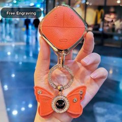Elegant orange wuling binguo key cover for the 2024 cloud sky edition, featuring a butterfly charm and free engraving option.