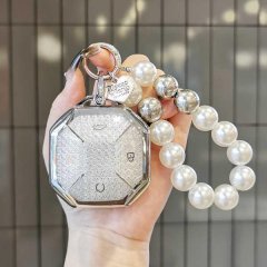A hand holds a jetour traveler key cover for jetour shanhai t2, featuring a sleek, octagonal design with a glittery silver fi...