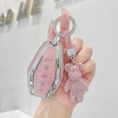 A hand holds a jetour key cover case, featuring a pink glittery design with a matching teddy bear charm, offering stylish and...