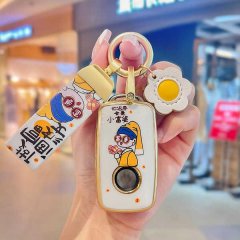 A hand holds a stylish skoda key cover featuring a cartoon character and the phrase you are a little rich lady, paired with a...