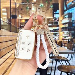 Elegant land rover key cover for range rover evoque & defender, featuring a gold-trimmed design with a braided white rope and...