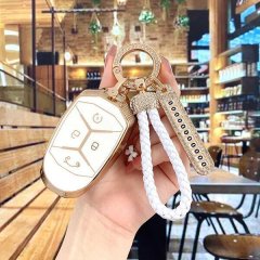 Elegant lynk & co 01 key cover with gold accents and a white braided lanyard, perfect for stylish women.
