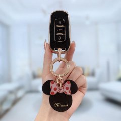 A hand holds a rui lan x3 pro key cover for geely vehicles, featuring a minnie mouse design with a red polka-dot bow and minn...