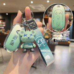 A hand holds a yadea m5/e8/q6 key cover, featuring a gradient green design with a cute bear charm and a strap. the front view...