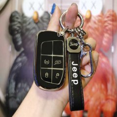 A hand holds a sleek black jeep key cover with a matching lanyard, designed for compass, renegade, and grand cherokee models,...