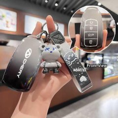 A hand holds a sleek, black chery arrizo 8 key cover with a soft tpu case, featuring a cute bear charm and a stylish wrist st...