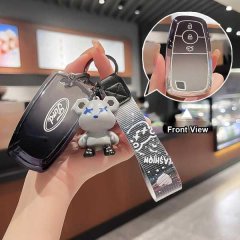 A hand holds a sleek ford key cover with a stylish bear charm and patterned strap, showcasing its front view in a modern reta...