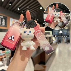 A hand holds a mitsubishi outlander key cover featuring a gradient pink design with the mitsubishi logo, accompanied by a cut...