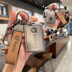 Volvo key cover for xc60, s90, xc40 featuring a sleek metal design with wooden strap and shise branding, shown in front view.