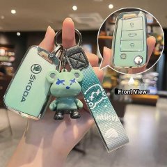 Skoda key cover in light green, featuring a cute bear charm and wrist strap, shown with front view of the key fob.