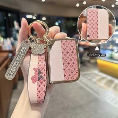 Elegant lynk & co 03 tpu key cover with pink monogram pattern, featuring a decorative wrist strap and crystal charm for styli...