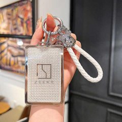 A hand holds a sleek zeekr card key cover with a glittery finish and zeekr logo, featuring a white braided lanyard and a deco...