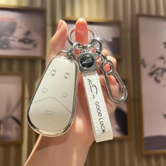 A hand holds a sleek white key cover for voyah free & pursuit ev keys, featuring a good luck strap and a modern design with b...