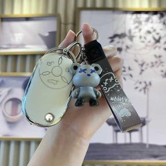 A hand holds a stylish benteng xiaoma 2024 key cover featuring a cute horse design, accompanied by a playful bear charm and a...