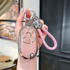 A hand holds a pink benteng xiaoma 2024 key cover featuring a cute horse design, adorned with a braided pink strap and decora...