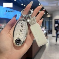 A hand holds a stylish nissan key cover for models like sylphy, x-trail, and qashqai, featuring a glittery design and a decor...