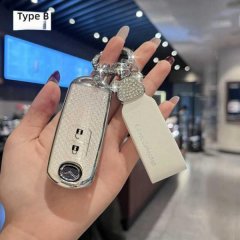A hand holds a stylish, glittery key cover for mazda vehicles, featuring a decorative charm and a sleek design, labeled type ...