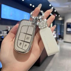 A hand holds a jeep key cover for cherokee, compass, and grand cherokee, featuring a glittery design with a matching keychain...