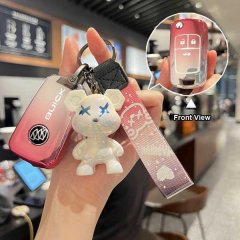 A hand holds a red buick key cover for excelle, verano, regal & gl8, featuring a cute bear charm and a decorative strap, with...