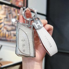 Elegant lexus key cover for es, nx, ux, ls models, featuring a sleek metallic design with a h charm and fashion leather strap...