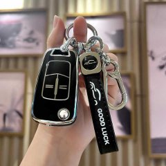 A hand holds a sleek black opel astra insignia fold key cover with a tpu design, featuring a good luck strap and a car logo c...