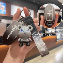 A hand holds a 2022 nissan sylphy 14th gen silicone key cover with a cute bear charm, showcasing its front view and sleek des...