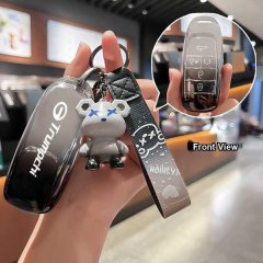 Hand holding gac aion s key cover for 2024 lx 580/630, featuring a sleek black design with trumpchi branding and a cute bear ...